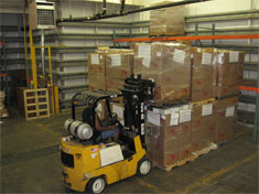 A 40-foot container of books being loaded in the BFA warehouse.