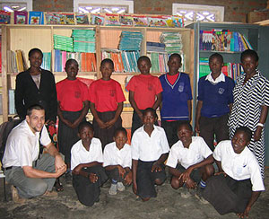 Peace Corps Volunteers in Uganda distribute a container.