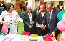  Chief Justice Mrs. Georgina Theodora Wood examines books donated by Books For Africa, Thomson Reuters and the Africa Committee of ABA with Martin Amidu, Former Attorney General of the Republic of Ghana.