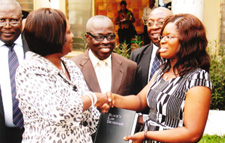 Yvonne Fiadjoe presents Black’s Law Dictionary. (Foreground: Her Ladyship Mrs. Georgina Theodora Wood, Chief Justice of the Republic of Ghana. Background: Director of the Ghana School of Law, Mr. George Sarpong and to his right, Mr. Martin Amidu, Former Attorney General of the Republic of Ghana)