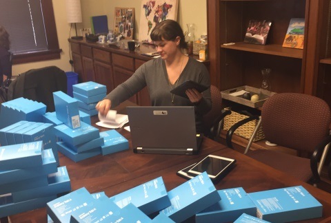 BFA Database and Development Coordinator Erin Yates works to prepare and catalog Samsung Galaxy tables for shipment to Africa.