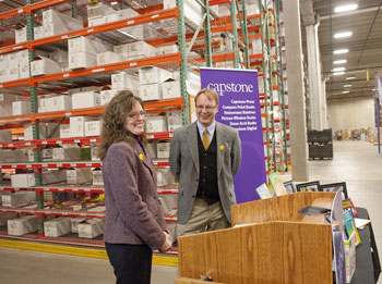 Lisa Hanson, human resources director of Coughlan Companies, and Patrick Plonski, executive director of Books For Africa, celebrate the $5 million Capstone donation.