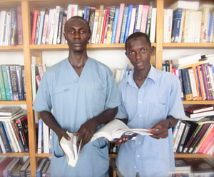 Nurses from the morning shift help shelve books and check out the new collection.
