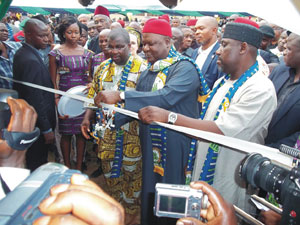 Sir Emeka Offor (in yellow) at the ribbon cutting ceremony for the largest book donation in Books For Africa's history.