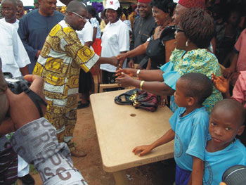 Sir Emeka Offor (in yellow) greets future recipients of BFA books. The Sir Emeka Offor Foundation funded and distributed eight BFA sea containers of books and computers throughout Nigeria.