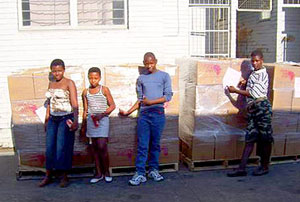 Students show off palets of delivered books